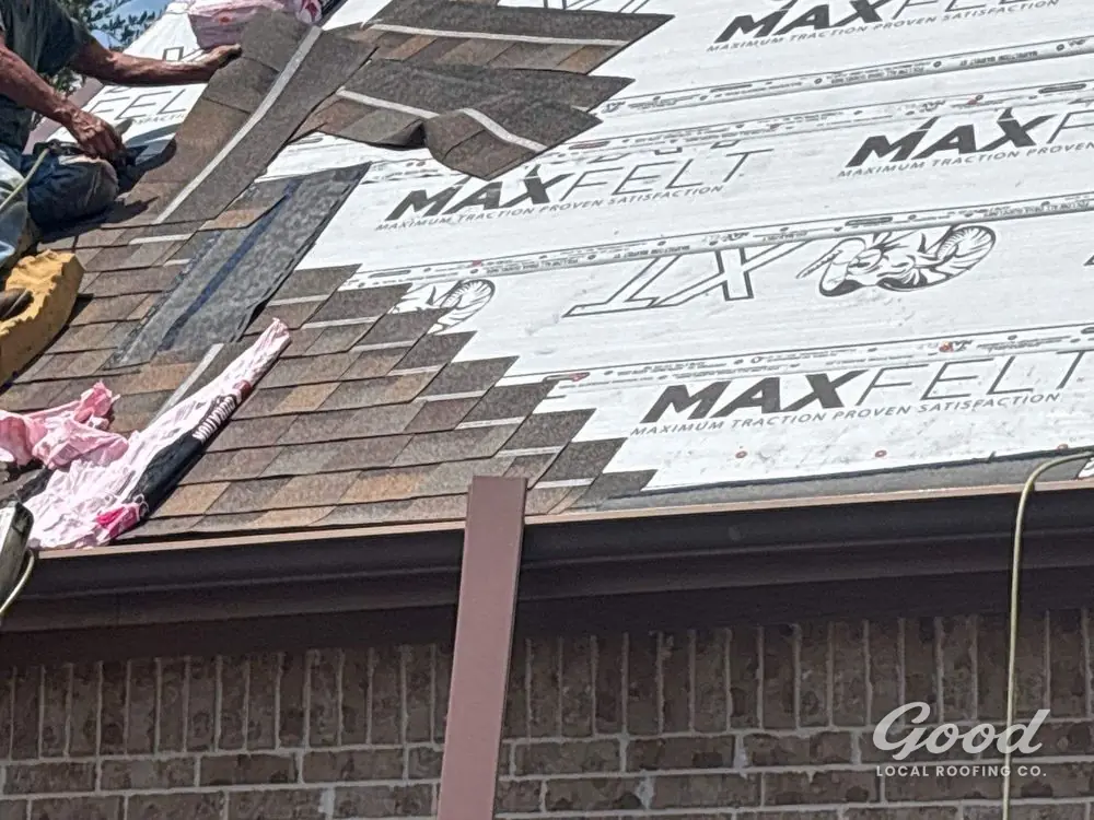 Architectural shingle courses set over synthetic underlayment on a roof slope.